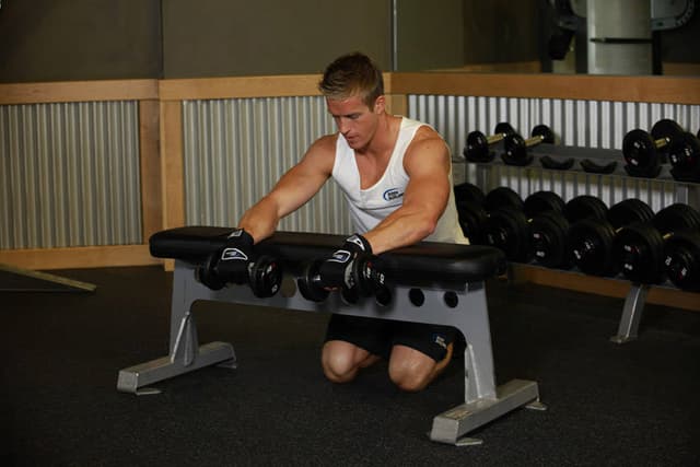 Palms-Down Dumbbell Wrist Curl Over A Bench