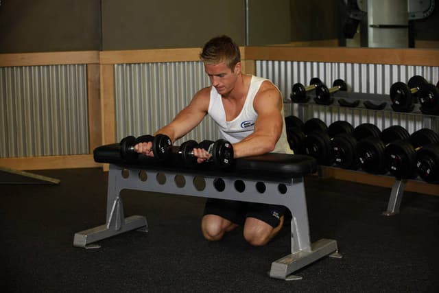Palms-Down Dumbbell Wrist Curl Over A Bench - view 2